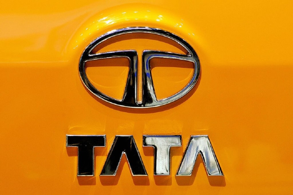 A Tata Motors badge on a yellow car in India.