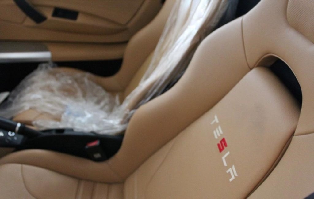 Tan Tesla Roadster seats with plastic still on