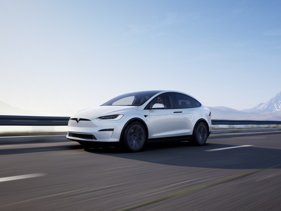 The largest vehicle in the Tesla lineup, the Model X, cruises a highway.