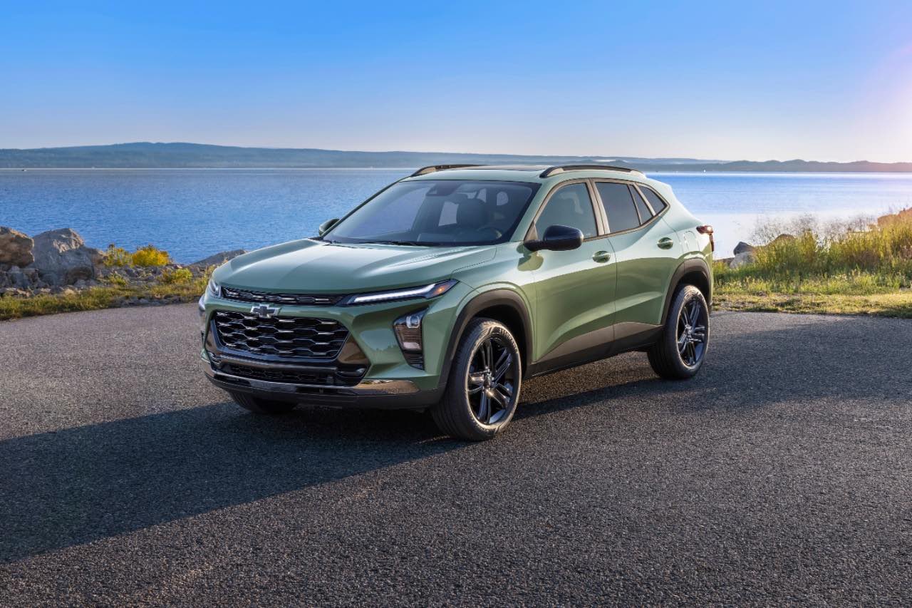 A green 2024 Chevrolet Trax sits in front of a lake.