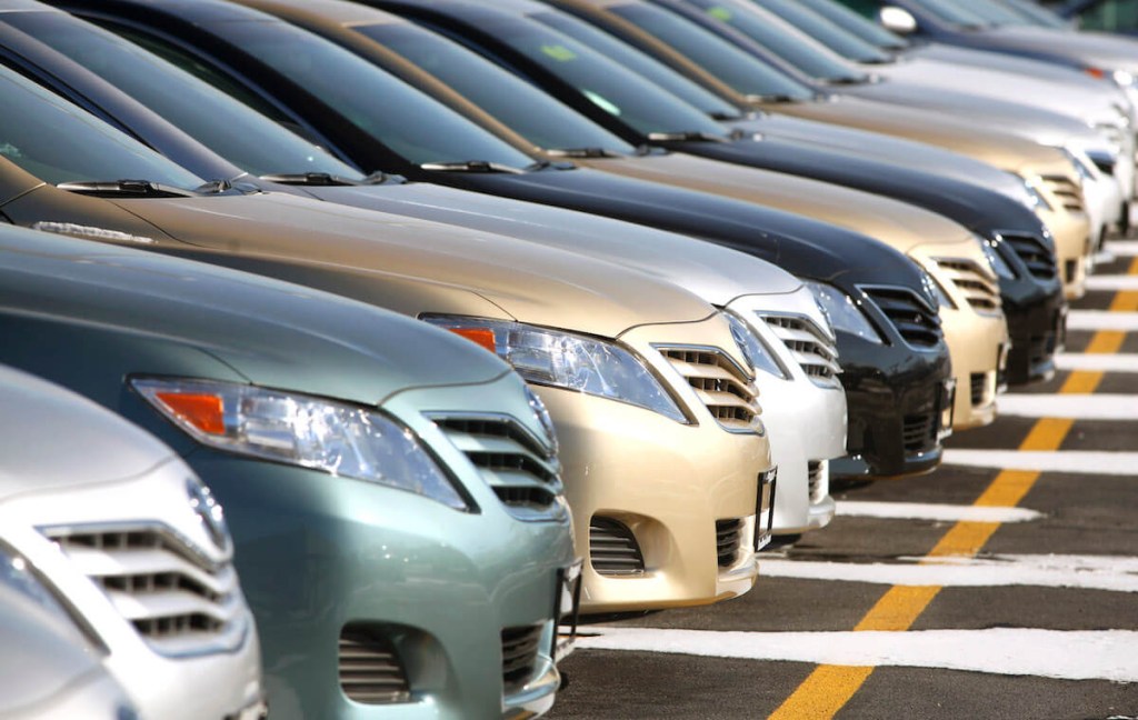 A row of Toyota Camrys' parked in a dealership lot