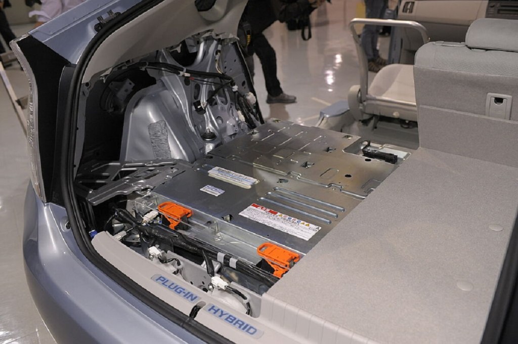 A replacement Toyota hybrid battery sits along a floor pan. 