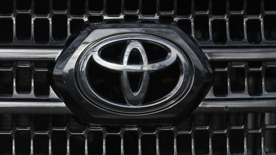 A silver Toyota logo on the grille of a car. Certain Toyota models have seen sales declines so far in 2023