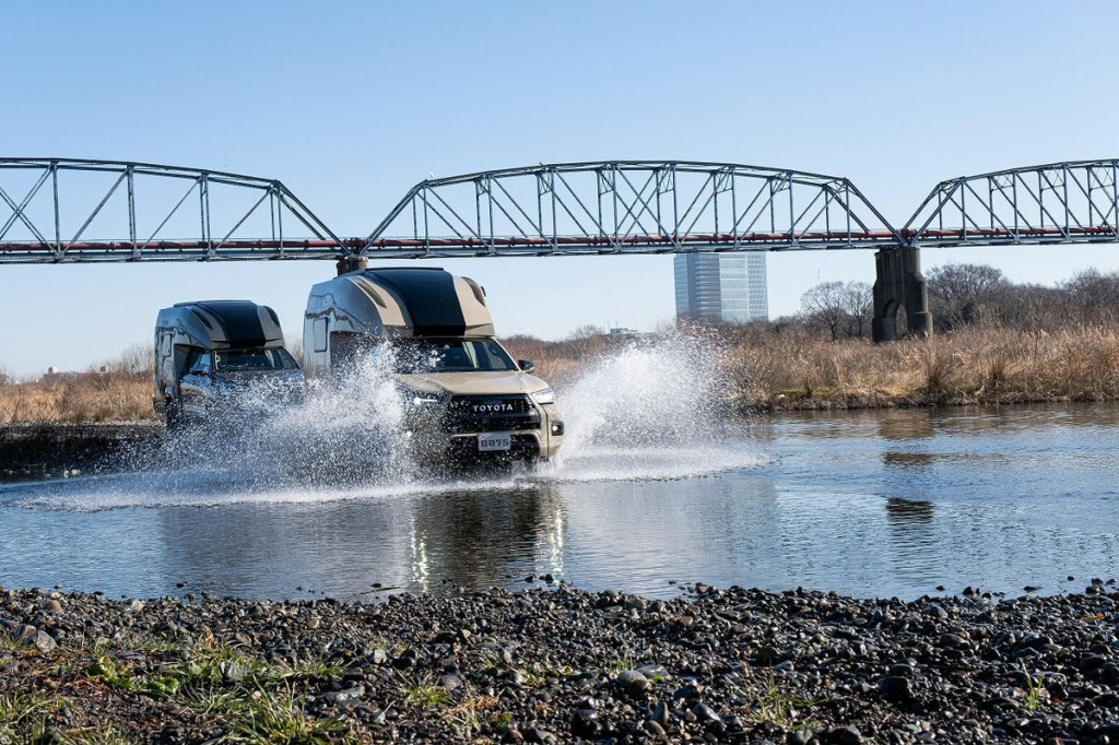 The Toyota Hilux BR-75 by Direct Cars is driving through water.