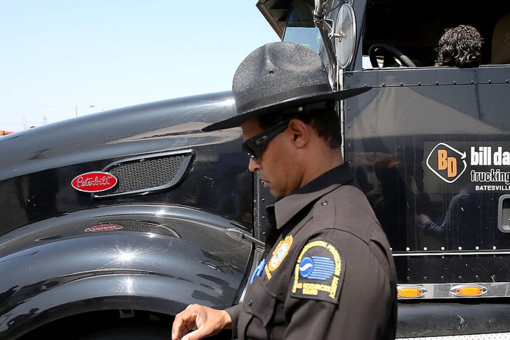 Highway Patrol issuing a truck emissions citation