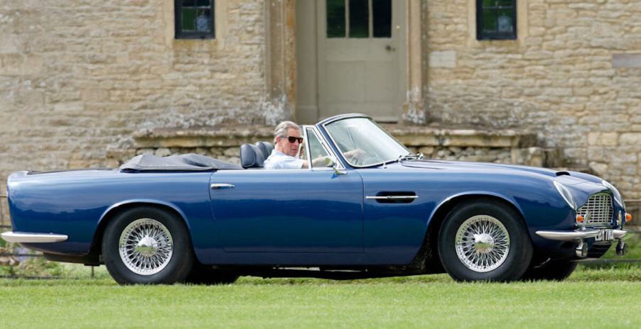 King Charles in blue vintage Aston Martin