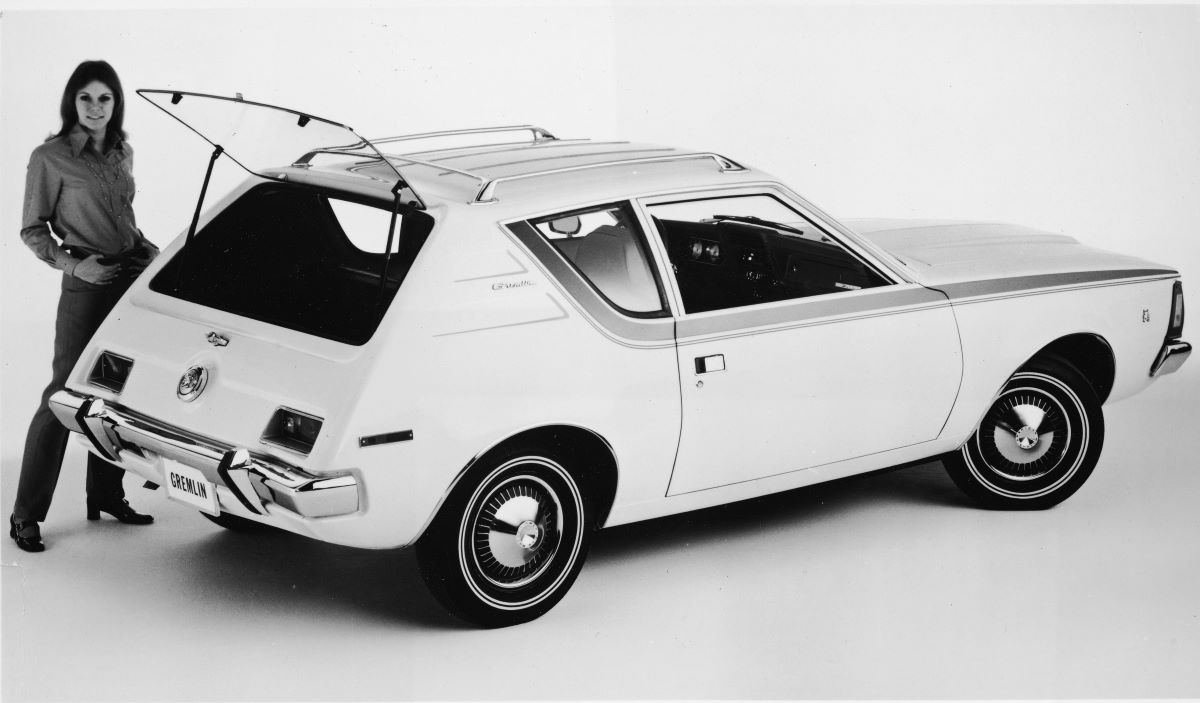 A black and white image of a 1970 AMC Gremlin subcompact car model with its rear liftgate hatch open