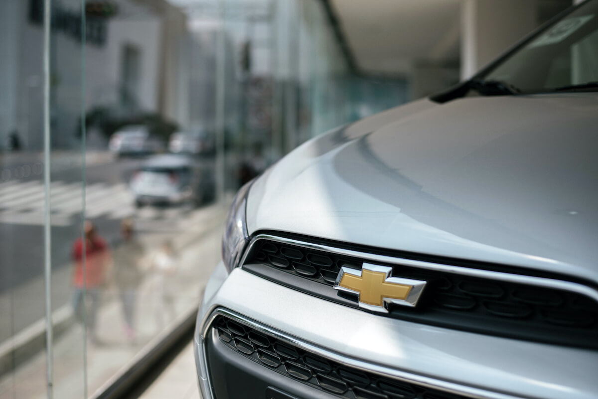 A close up of the Chevy logo on a car at a dealership. The Bolt is one of the Chevy models selling well this year.