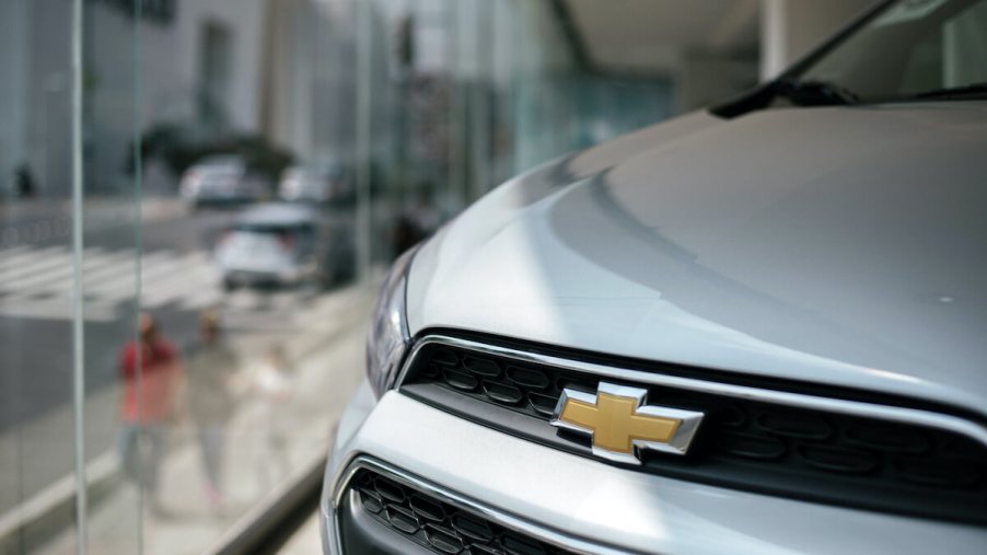 A close up of the Chevy logo on a car at a dealership. The Bolt is one of the Chevy models selling well this year.