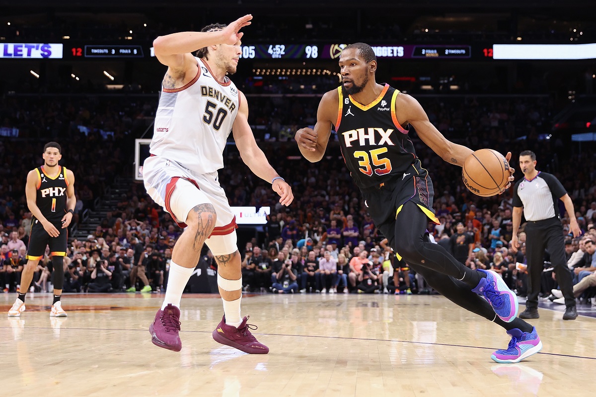 MAY 05: Kevin Durant #35 of the Phoenix Suns handles the ball against Aaron Gordon #50 of the Denver Nuggets during Game Three of the NBA Western Conference Semifinals at Footprint Center on May 05, 2023 in Phoenix, Arizona | Christian Petersen via Getty Images
