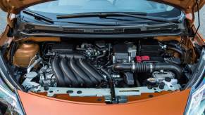An orange 2017 Nissan Versa Note subcompact hatchback economy car displaying its powertrain setup