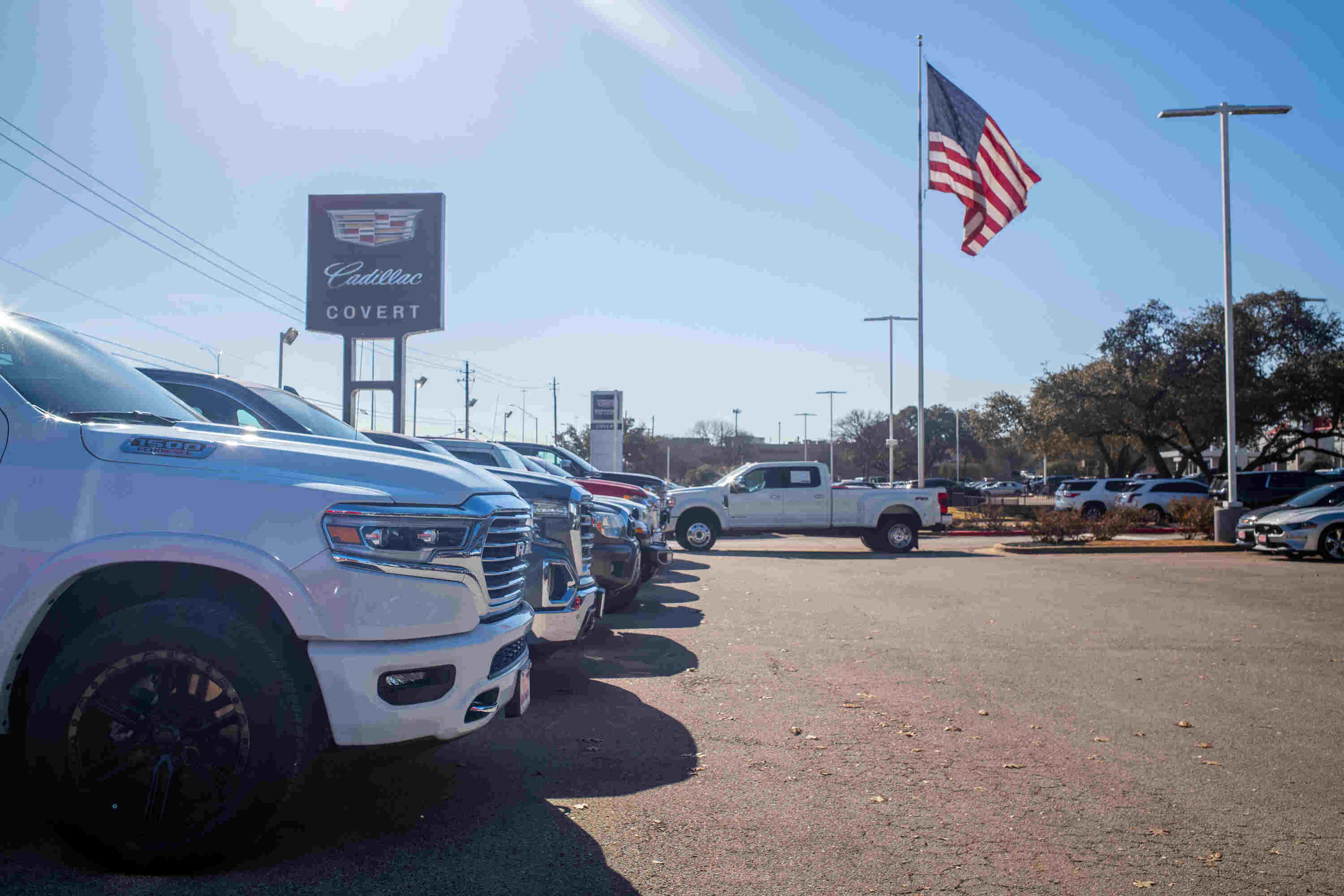 A dealership with multiple pickup trucks for sale.