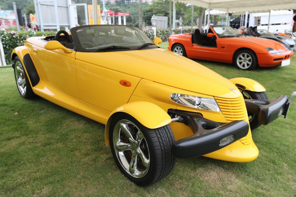 A yellow plymouth prowler at an auto show