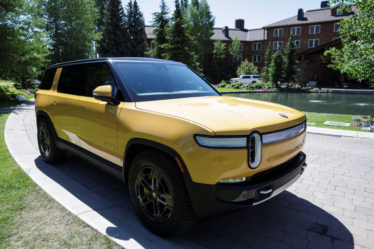 A yellow Rivian R1S full-size electric SUV model parked outside the Allen & Company Sun Valley Conference