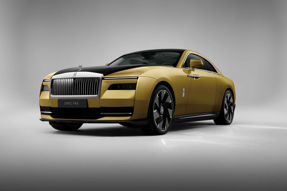 A yellow-gold Rolls-Royce Spectre ultra-luxury all-electric sports car souper coupe model