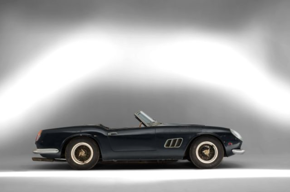1961 Ferrari 250 GT SWB California Spider in profile against a white background. 