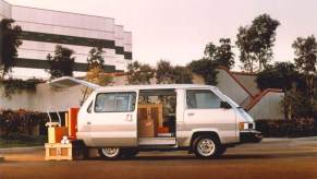 A retro looking Toyota van parked outside a building.
