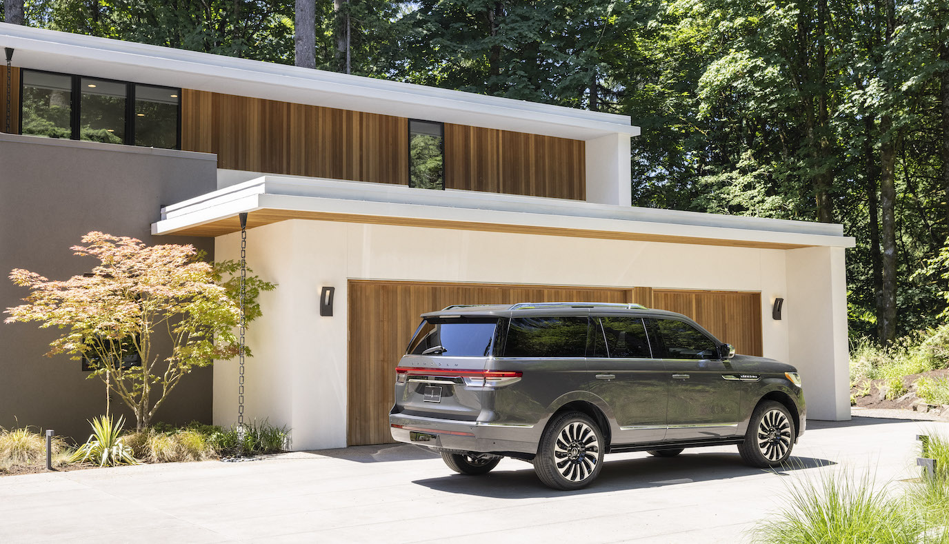 Lincoln sales for the Lincoln Navigator (pictured in a gray caviar parked in front of a garage) are on the up.