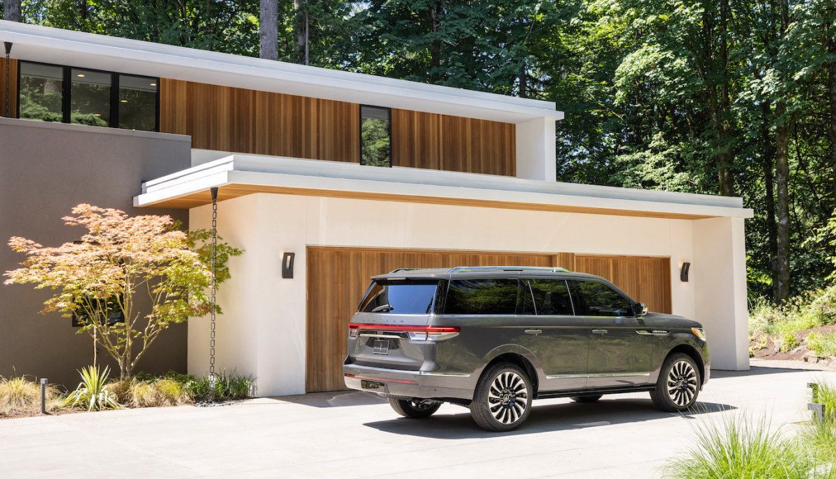 Lincoln sales for the Lincoln Navigator (pictured in a gray caviar parked in front of a garage) are on the up. 