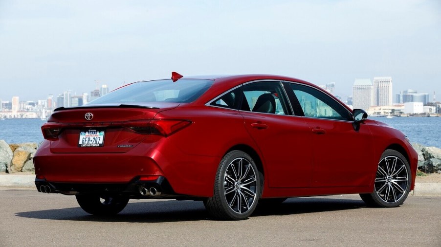 A 2022 Toyota Avalon shows off its rear-end styling next to a harbor.