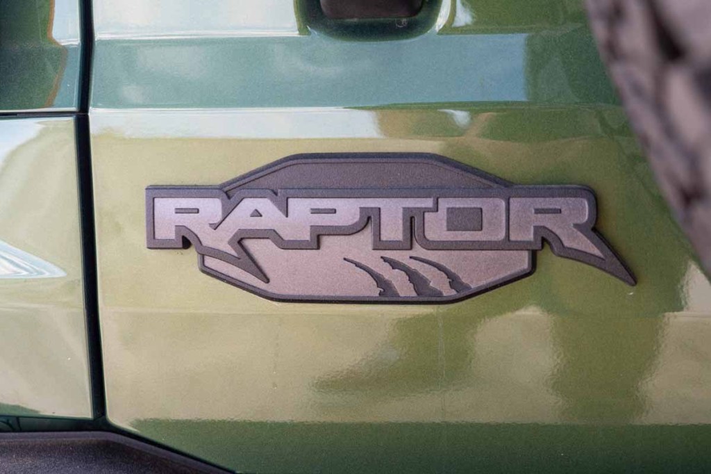 2022 Ford Bronco Raptor rear hatch door logo near spare tire on green paint