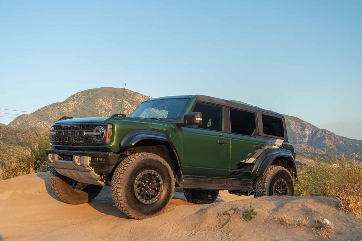 Green 2022 Ford Bronco Raptor atop a steep hill on the Cleghorn trail in southern California near palmdale.