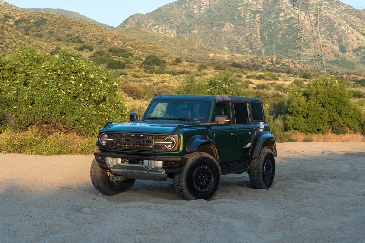 Green 2022 Ford Bronco Raptor on the Cleghorn Trail in Southern California at sunset during MotorBiscuit off-road testing