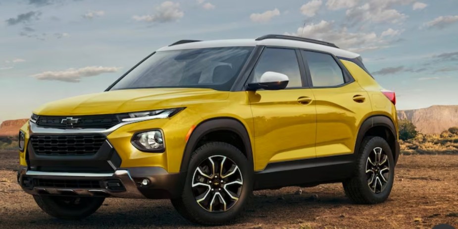 A yellow 2023 Chevrolet Trailblazer subcompact SUV is parked off-road. 