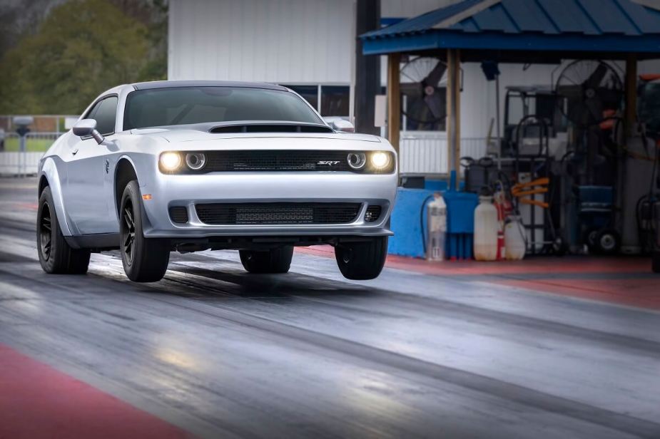 A 2023 Dodge Challenger SRT Demon 170 does a wheelie at the drag strip.