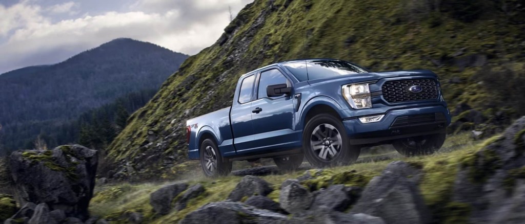 The 2023 Ford F-150 driving on a mountain road 
