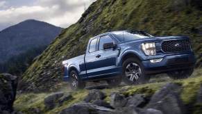 The 2023 Ford F-150 driving on a mountain road