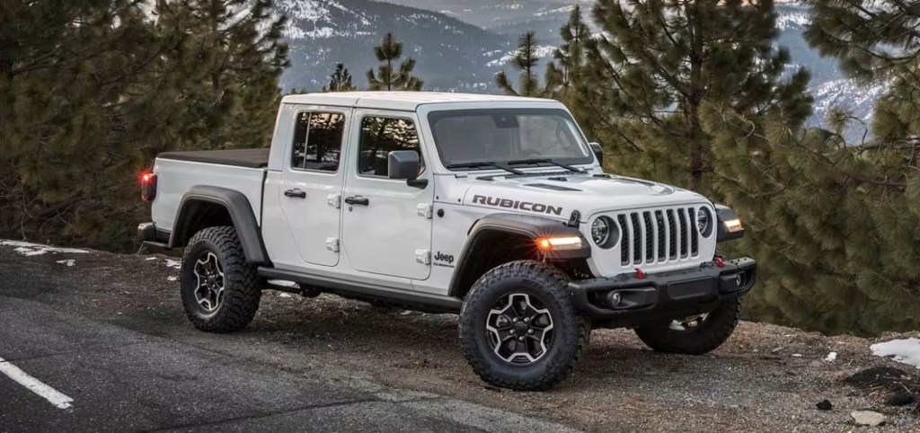 The 2023 Jeep Gladiator parked near trees on a mountain road