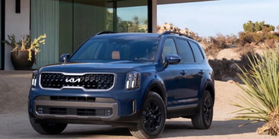 A blue 2023 Kia Telluride midsize SUV is parked outdoors. 