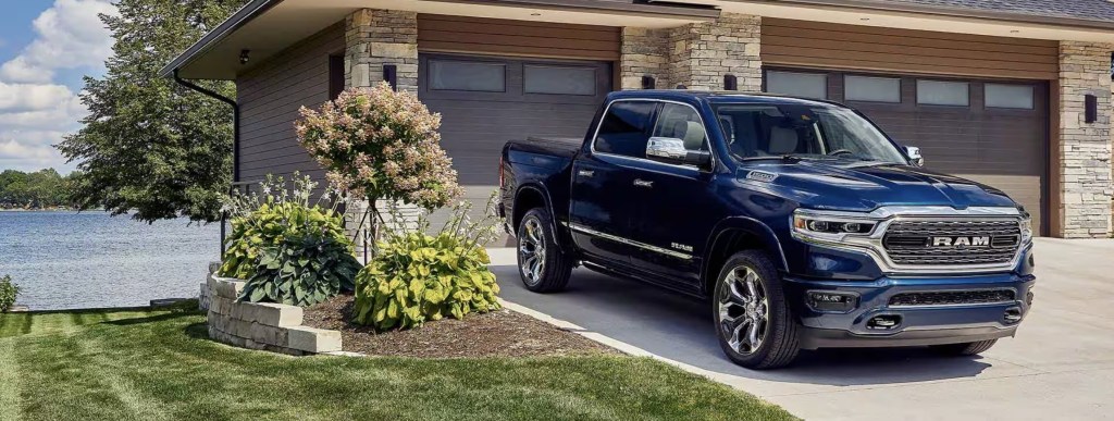 The 2023 Ram 1500 parked near a home 