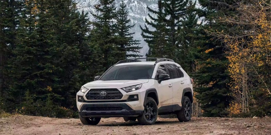 A white 2023 Toyota RAV4 small SUV is parked outdoors, can it handle high gas prices?
