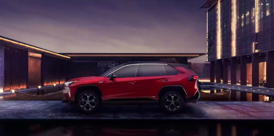 A red 2023 Toyota RAV4 Prime small plug-in hybrid SUV is parked. 