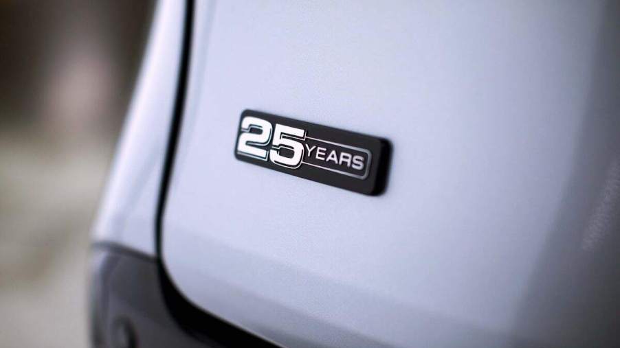 Close-up of a '25 Years' badge on a silver 2023 Toyota Sienna 25th Anniversary Special Edition minivan