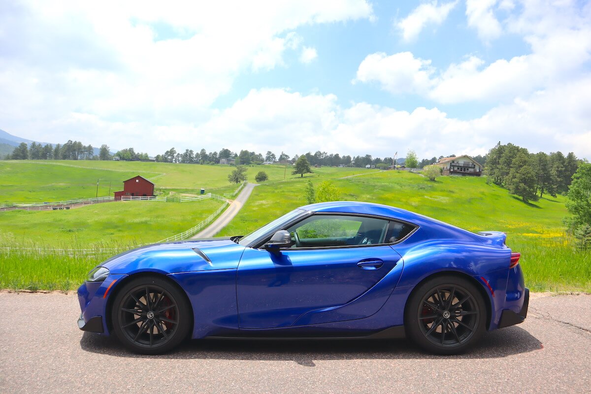 A side view of the 2023 Toyota Supra parked on a road.