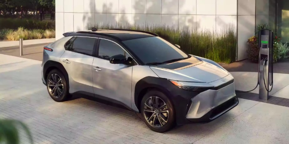 A gray 2023 Toyota bZ4X small electric SUV is charging. 