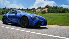 A front view of the 2023 Toyota Supra driving by.