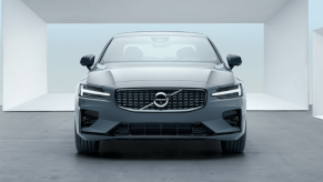 A front-facing 2023 Volvo S60 compact executive car/luxury sedan model with a background of white frames