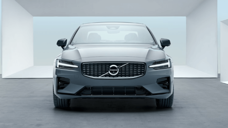 A front-facing 2023 Volvo S60 compact executive car/luxury sedan model with a background of white frames