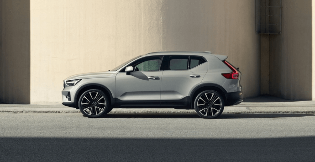 A side profile shot of a 2023 Volvo XC40 subcompact luxury SUV model parked at a street curb