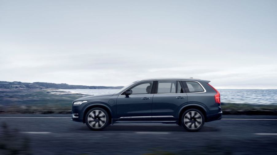 A side profile shot of a 2023 Volvo XC90 Recharge T8 AWD plug-in hybrid midsize luxury SUV in Denim Blue