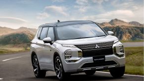The 2023 Mitsubishi Outlander PHEV driving on the road