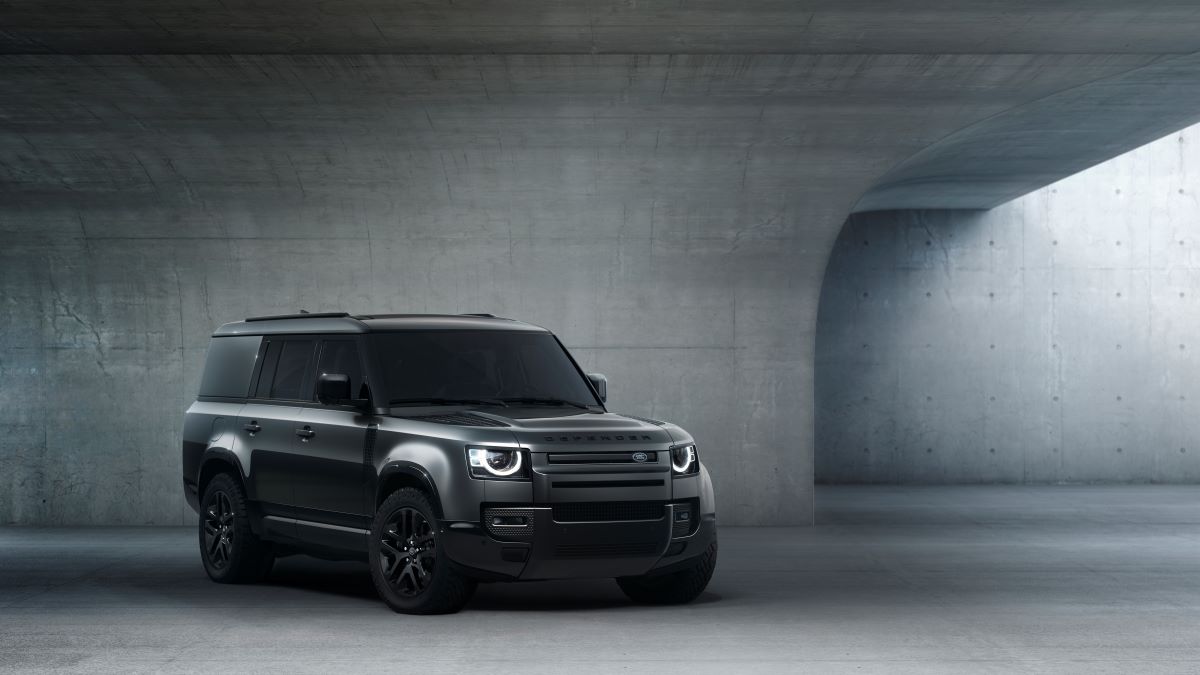 A 2024 Land Rover Defender 130 Outbound off-road luxury SUV model promotion photo in a concrete room
