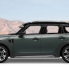 A side profile banner shot of a Mini Countryman subcompact crossover SUV model with a background of orange hills