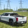 A white 2024 Chevrolet Silverado WT4 electric truck on display in a field.