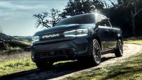 The 2025 Ram 1500 REV driving on a dirt road