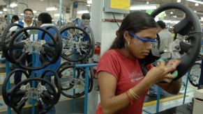 Silao factory worker assembling a general motors pickup truck in Mexico.